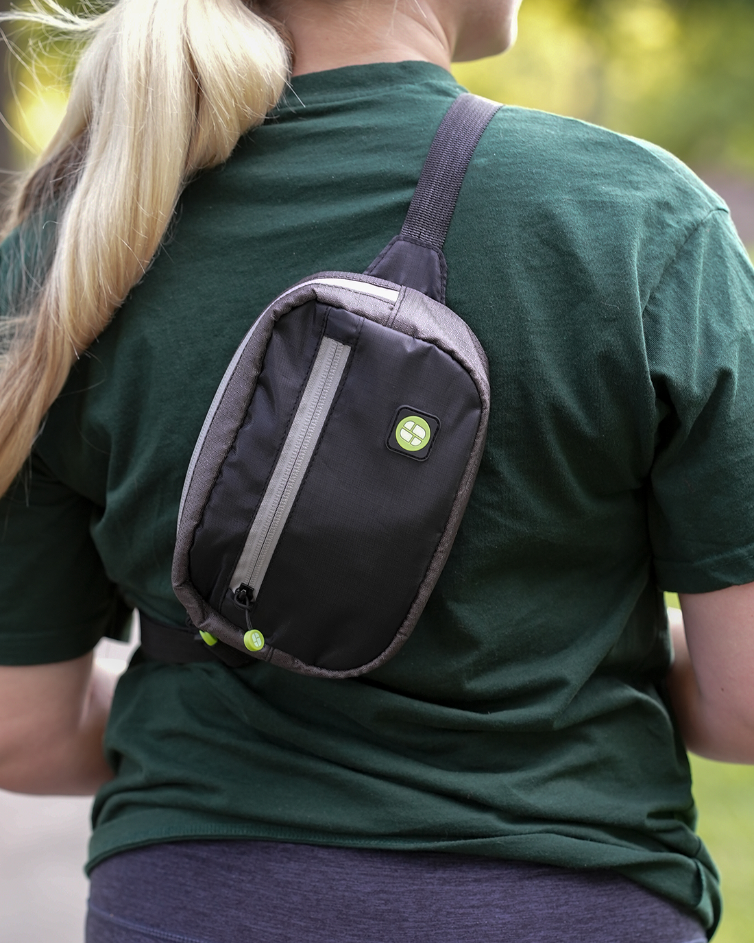 Image of women hiking with stashlogix's crestone bag over her shoulder. 