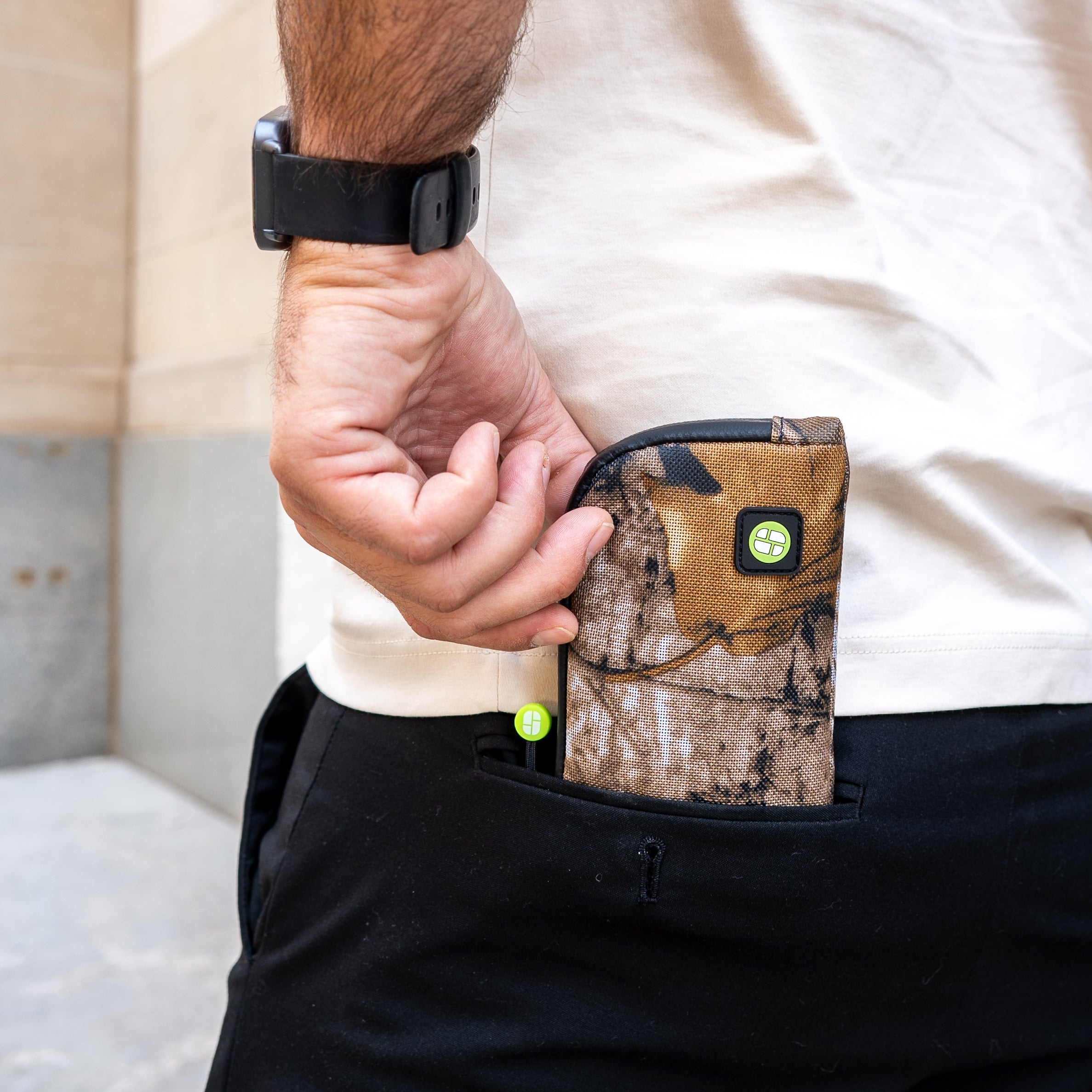 image of person pulling stashlogix's Dotsero dugout out of his back pocket. 
