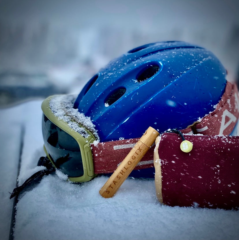 Image of ski helmet with bamboo StashTube and Dotsero in the snow.